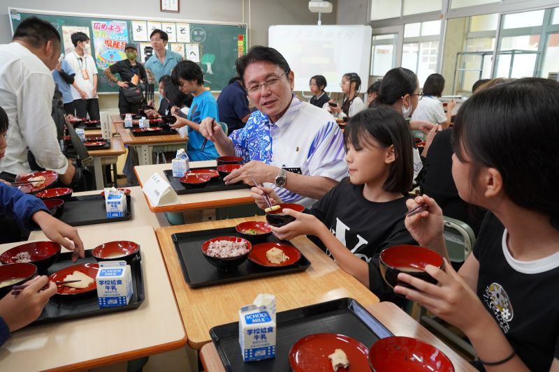 児童たちと会話をしながら給食を食べる様子